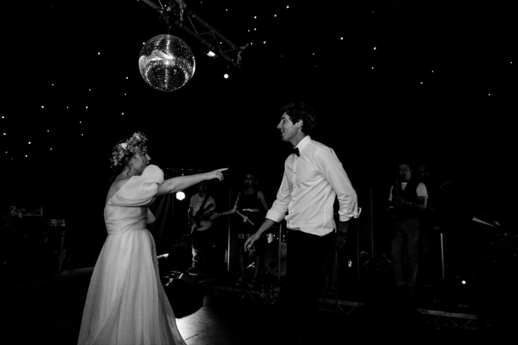 A bride and groom dance together at their alternative style wedding day