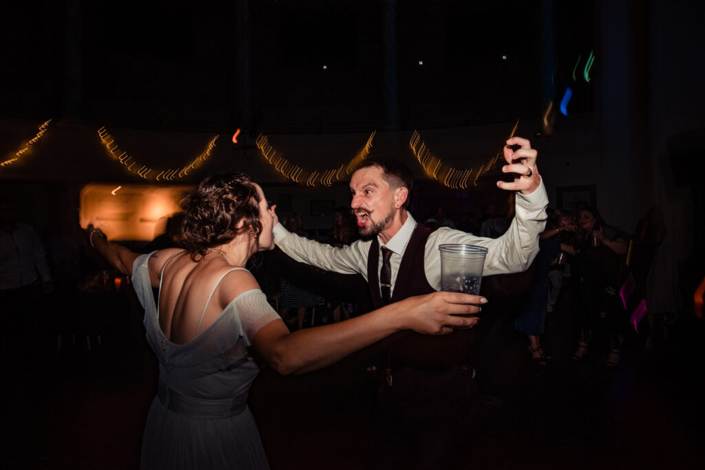 A bride and groom dance together at their alternative style wedding day, with a gig themed evening reception