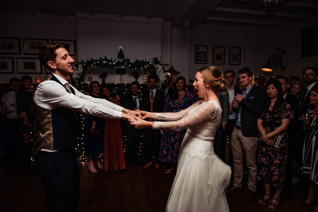A bride and groom dance together at their alternative style wedding day