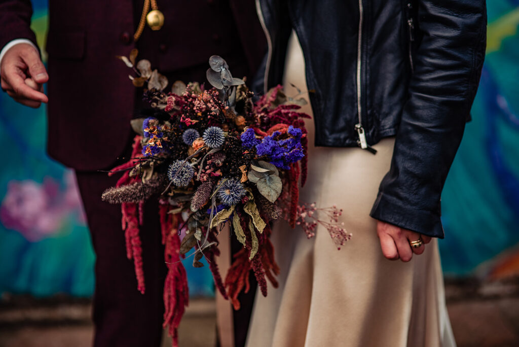 Details from a couple's shoot with a bride and groom after their wedding ceremony. The bride wears a leather jacket and embroidered trainers in a goth chick vibe.
