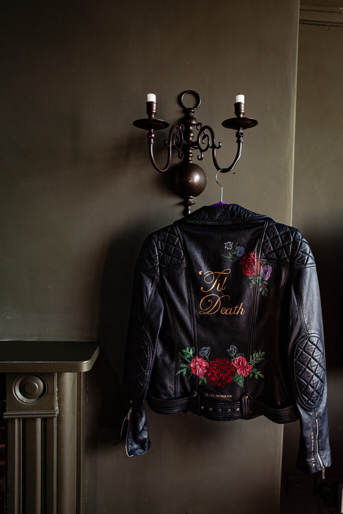 An Alternative wedding: The bride's leather jacket is black and decorated with roses. It reads: 'Til death' on the back. 