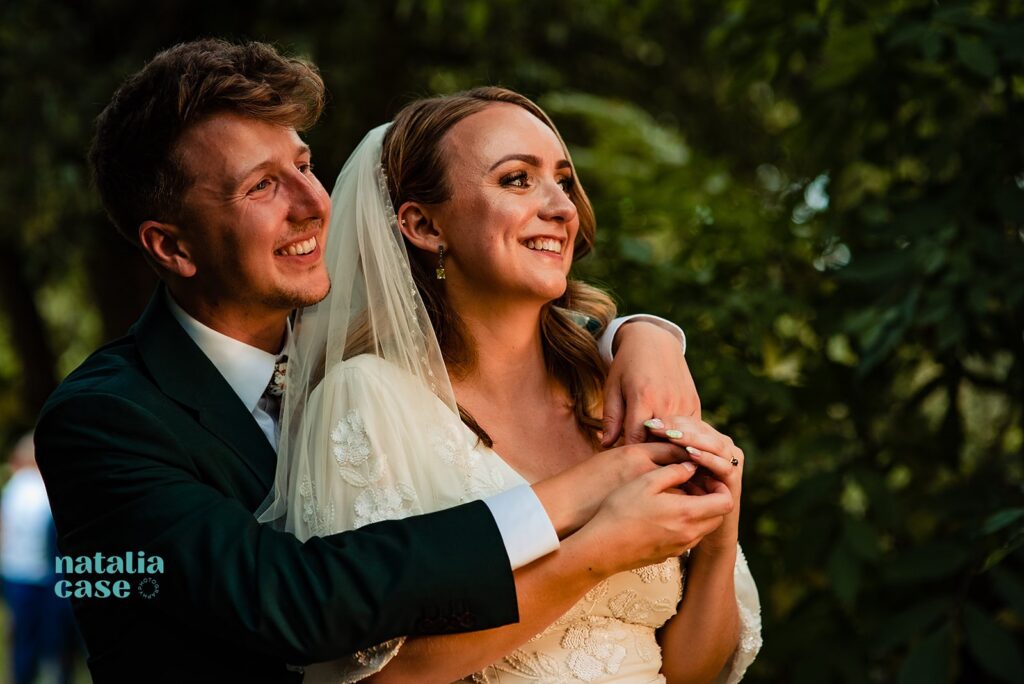 A bride and groom smile during their couple shoot on their Summer Wedding day at The Bingham Riverhouse, Richmond. 