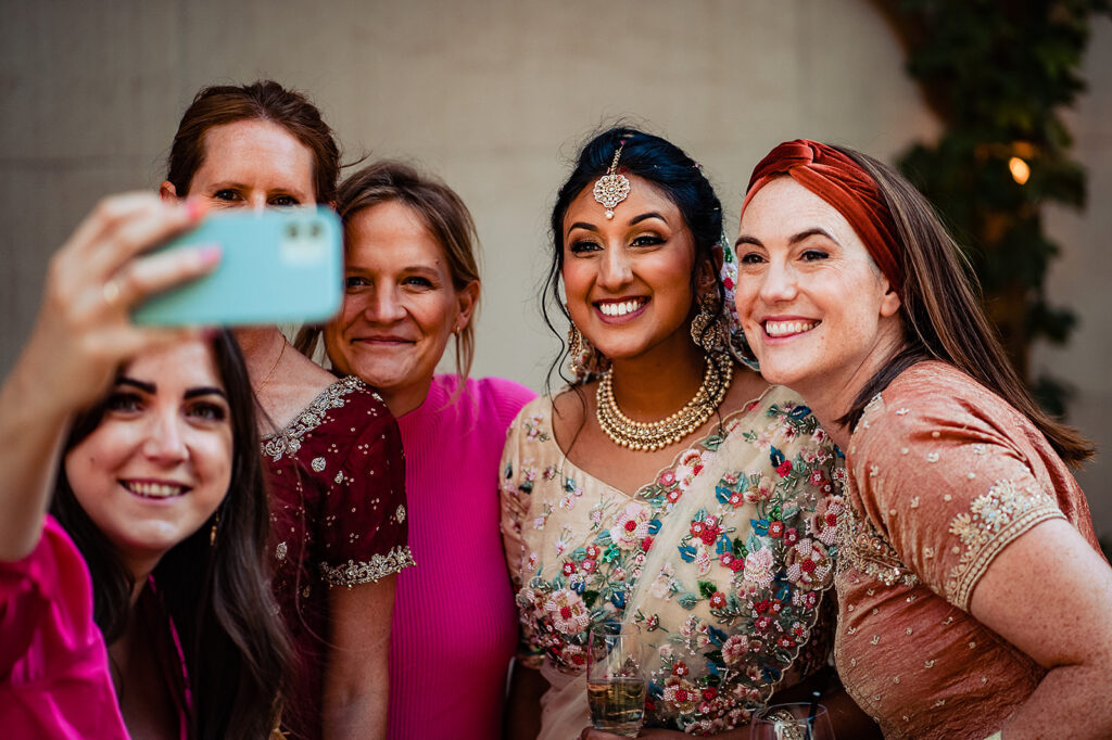 Guests taking a selfie with the bride at canapes at The Atlas Pub on Seagrave Road, South West London