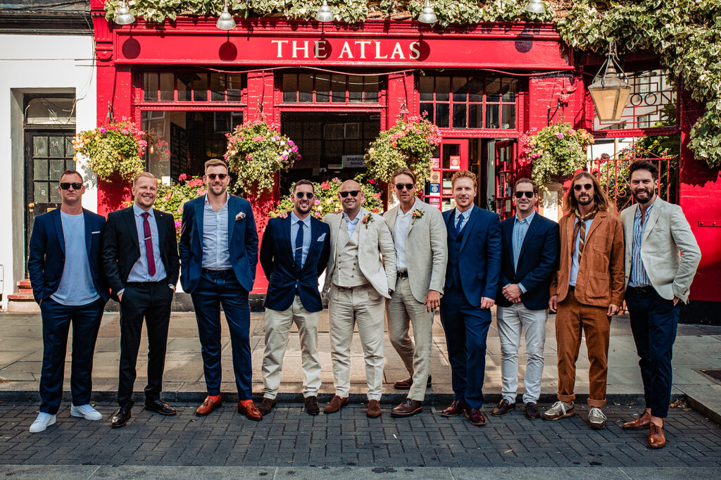 The groom and his groomsmen posing outside The Atlas Pub on Seagrave Road, South West London