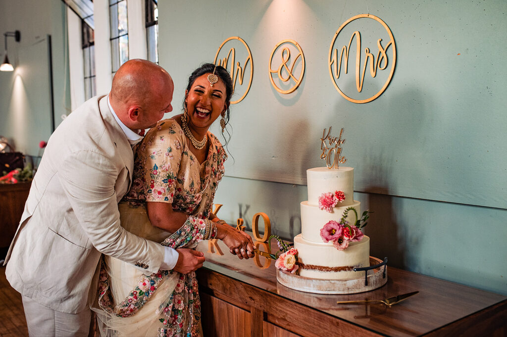 Bride and groom cutting cake 