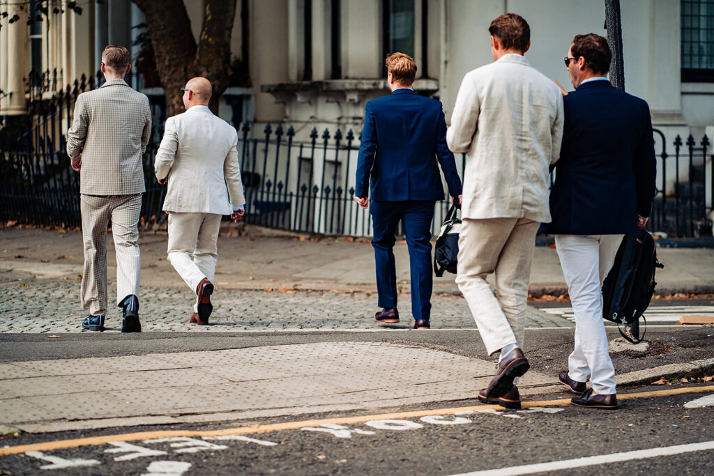 The groom's party crossing the road in central London, with their backs to the camera